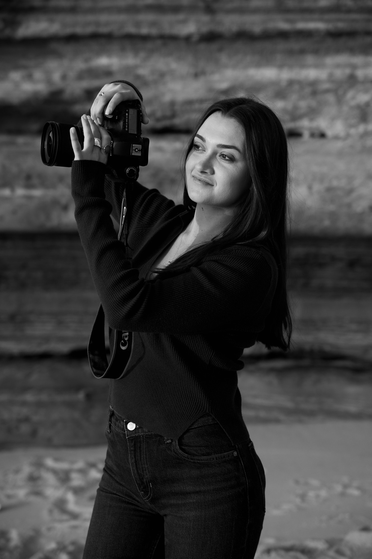 Hannah Stone holding her camera outdoors